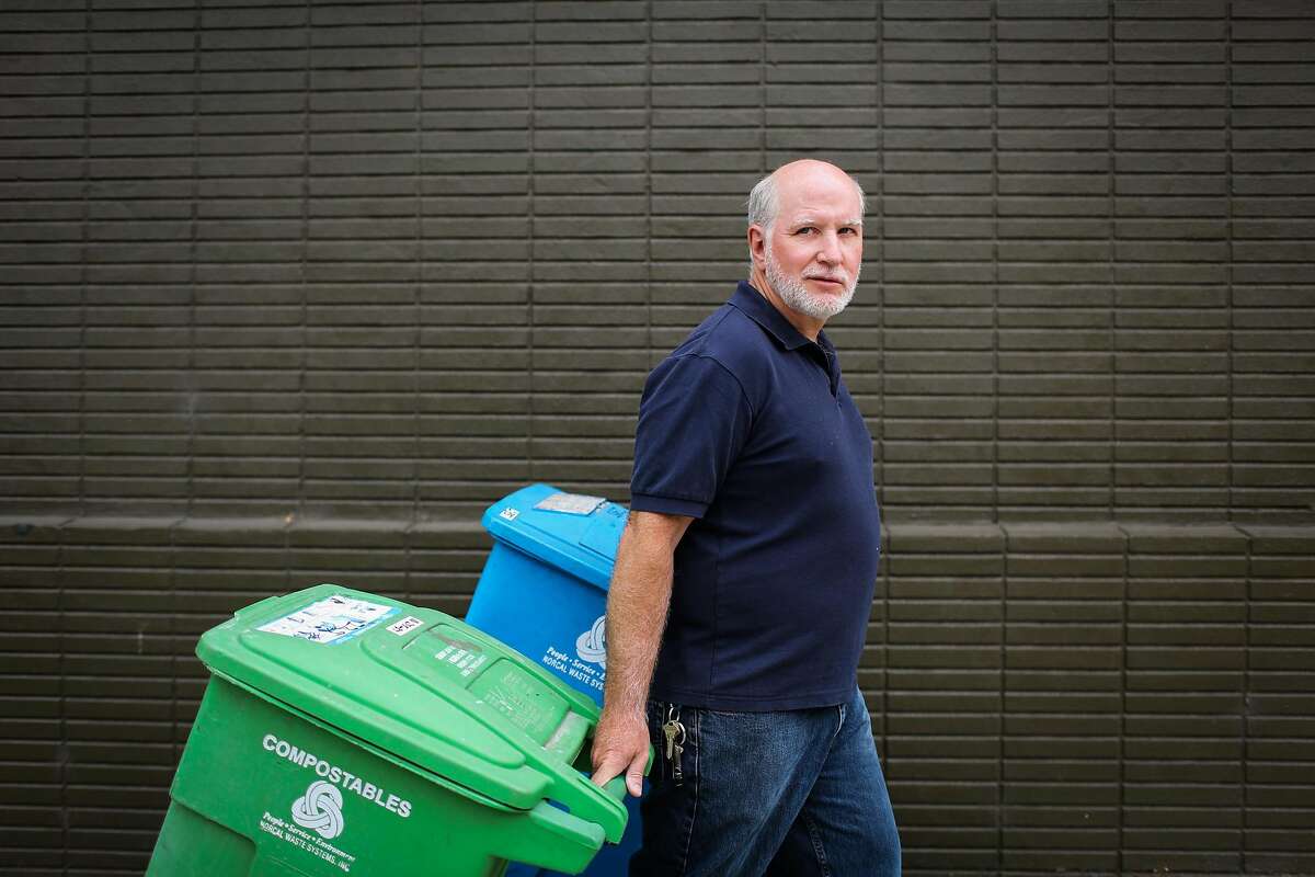 Chris Faust rolls his garbage bins during a portrait session in San Francisco, Calif., on Tuesday, Aug. 8, 2017.