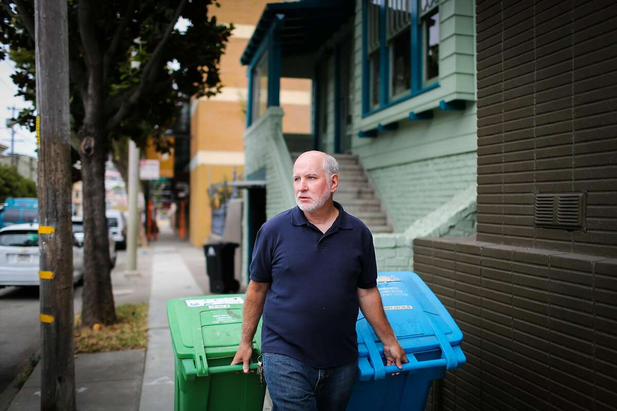Chris Faust rolls his garbage bins during a portrait session in San Francisco, Calif., on Tuesday, Aug. 8, 2017.
