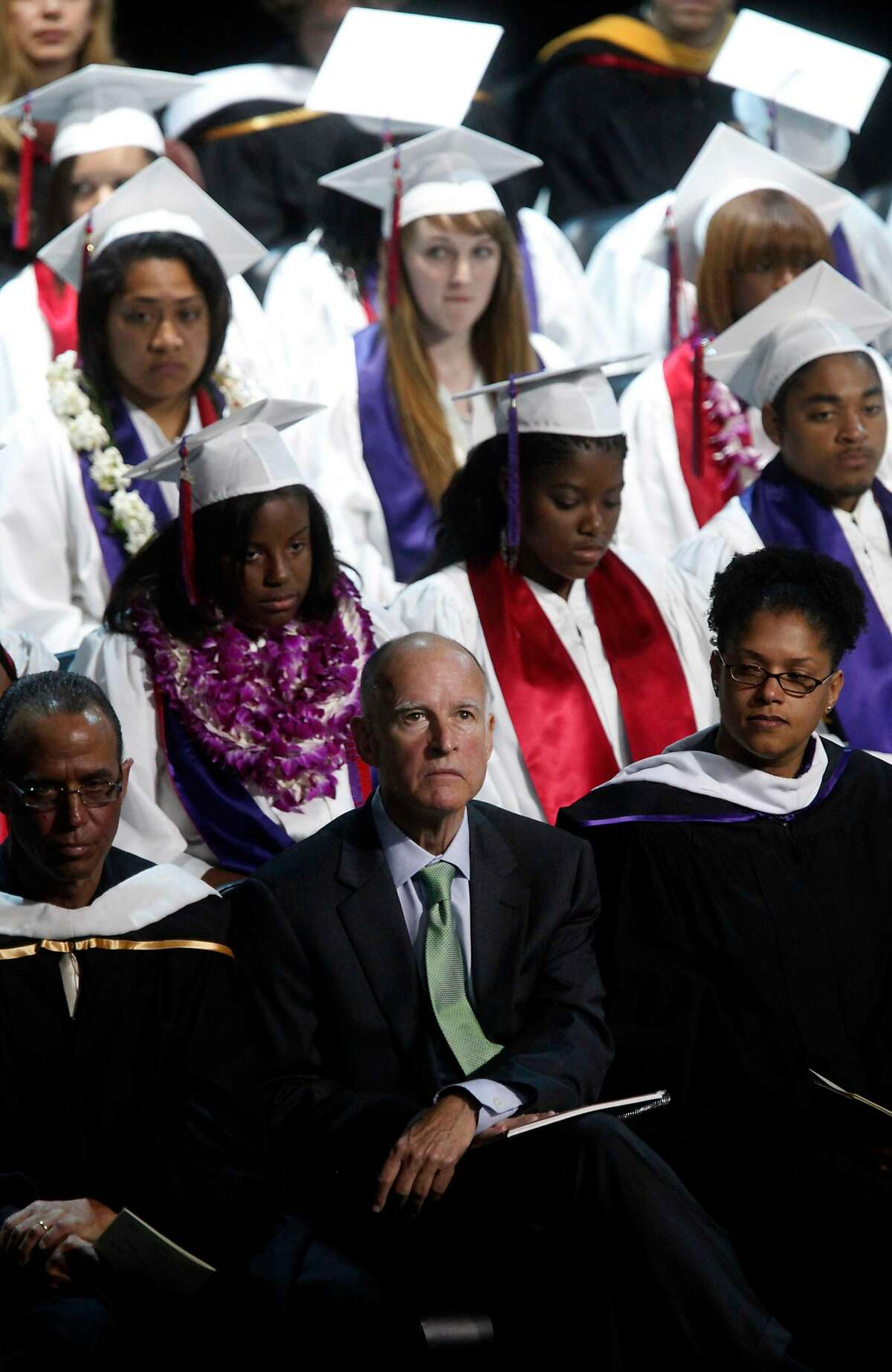 Attorney General and Gubernatorial candidate, Jerry Brown looks up after speaking at the Oakland School for the Arts graduation ceremony on Thursday June 17, 2010 in Oakland, Calif. Brown helped get the charter school off the ground years back is now being blamed by GOP nominee Meg Whitman for the demise of Oakland public schools.