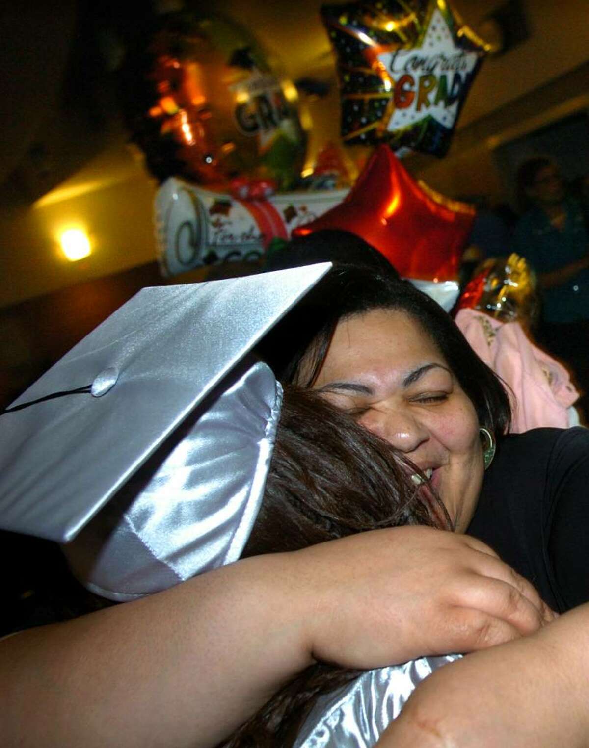 Barbara Jones hugs her daughter Tavarrea after graduating at Bridge Academy's 13th Annual Commencement Exercises held at Thurgood Marshall Middle School in Bridgeport, Conn. on Wednesday evening June 16, 2010.