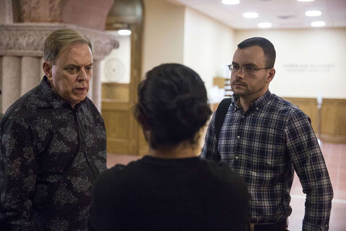 Joseph talks to Jamey Bartram, left, and Joseph Montaldi in the Bexar County Courthouse while waiting to get his gender marker changed in San Antonio, Texas on April 6, 2017. His full name is withheld for his safety and privacy.