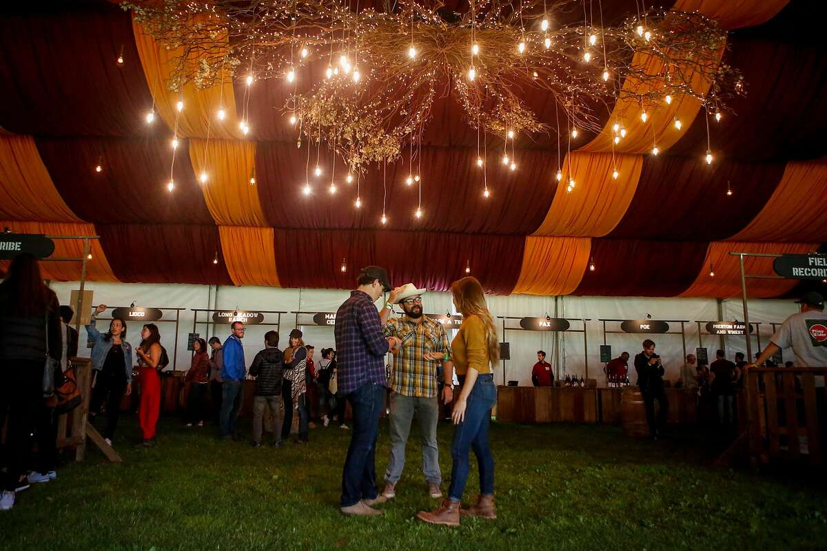 Festival goers mingle in the Wine Lands tent during the 10th annual Outside Lands Festival in Golden Gate Park in San Francisco on Friday, August 11, 2017.