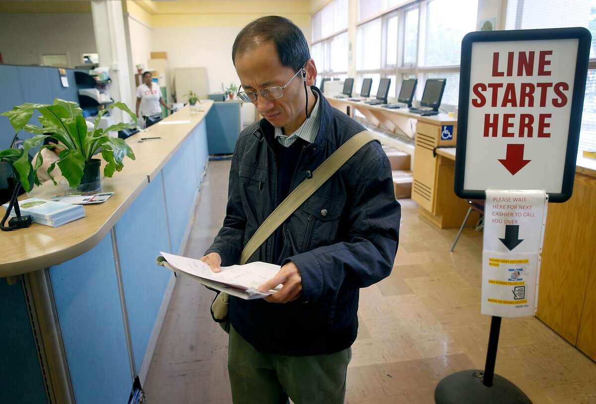 Simon Chan reviews his paperwork after discovering that he was inadvertently charged tuition fees when registering in person for a sculpting class at CCSF in San Francisco, Calif. on Wednesday, Aug. 9, 2017. The fee was refunded after the error was discovered. In an effort to boost enrollment, tuition fees will be waved for qualifying San Francisco residents for the next two academic years.