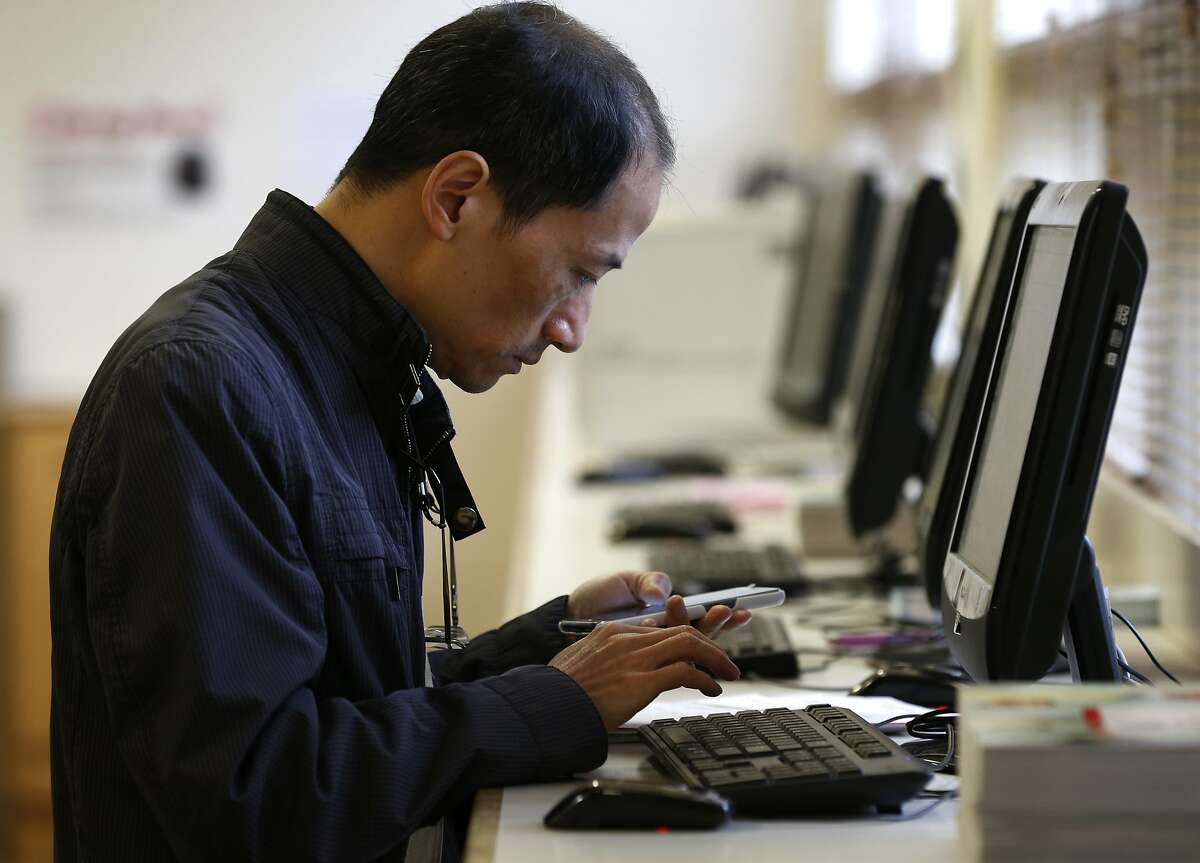 Simon Chan fills out an online form in the registration office for a sculpting class at CCSF in San Francisco, Calif. on Wednesday, Aug. 9, 2017. Chan initially registered in person but was incorrectly charged tuition fees so he was In instructed to fill out a form online to be able to have the fee refunded. an effort to boost enrollment, tuition fees will be waved for qualifying San Francisco residents for the next two academic years.