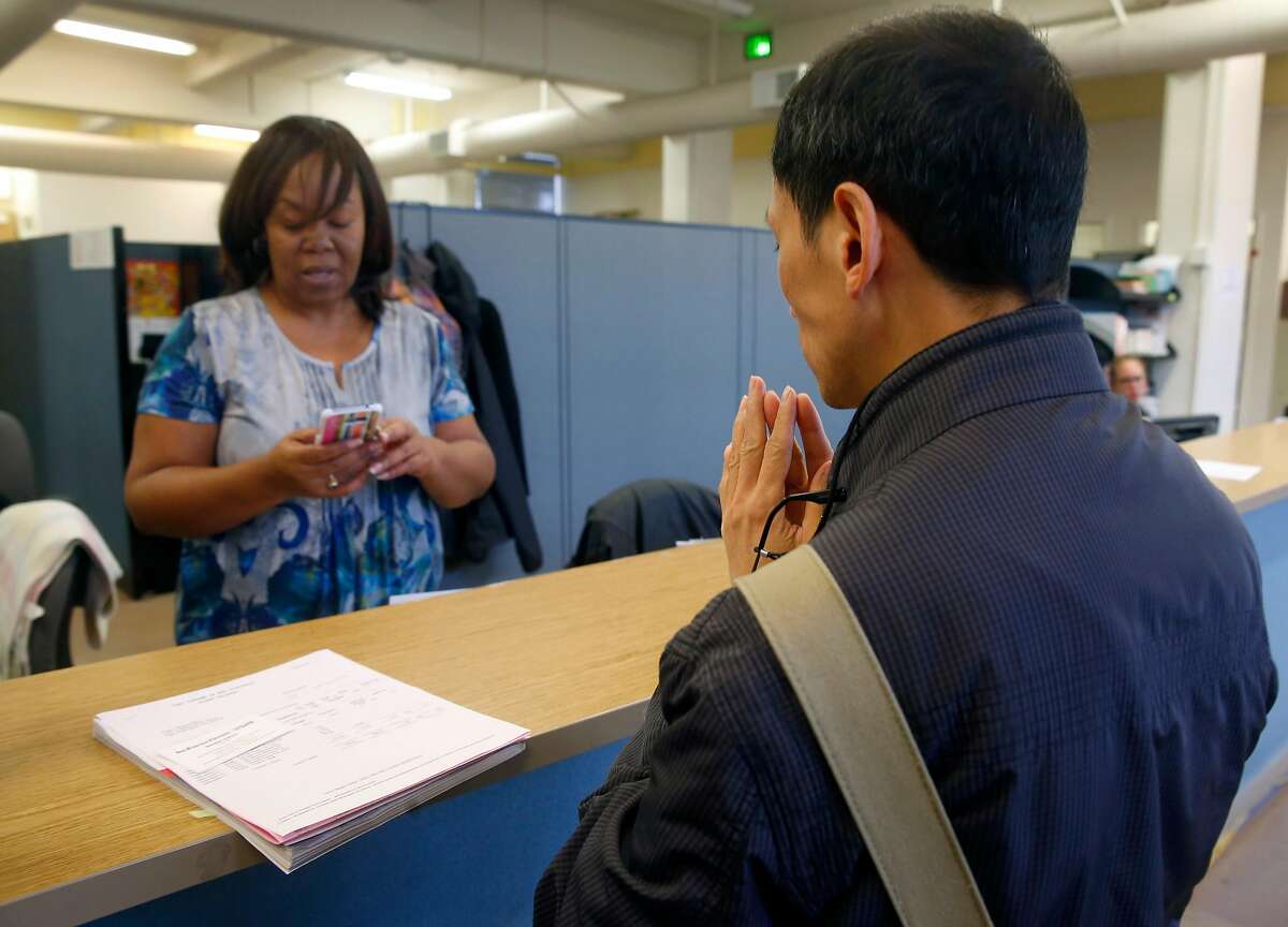 Associate registrar Patricia Gant helps Simon Chan get a refund after he was mistakenly charged tuition fees when registering for a sculpting class at CCSF in San Francisco, Calif. on Wednesday, Aug. 9, 2017. In an effort to boost enrollment, tuition fees will be waved for qualifying San Francisco residents for the next two academic years.