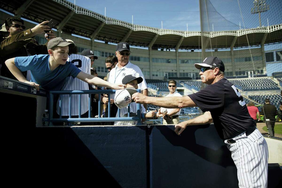 Yankees guest instructor Rich “Goose” Gossage signs autographs during a spring training workout Friday in Tampa, Fla.