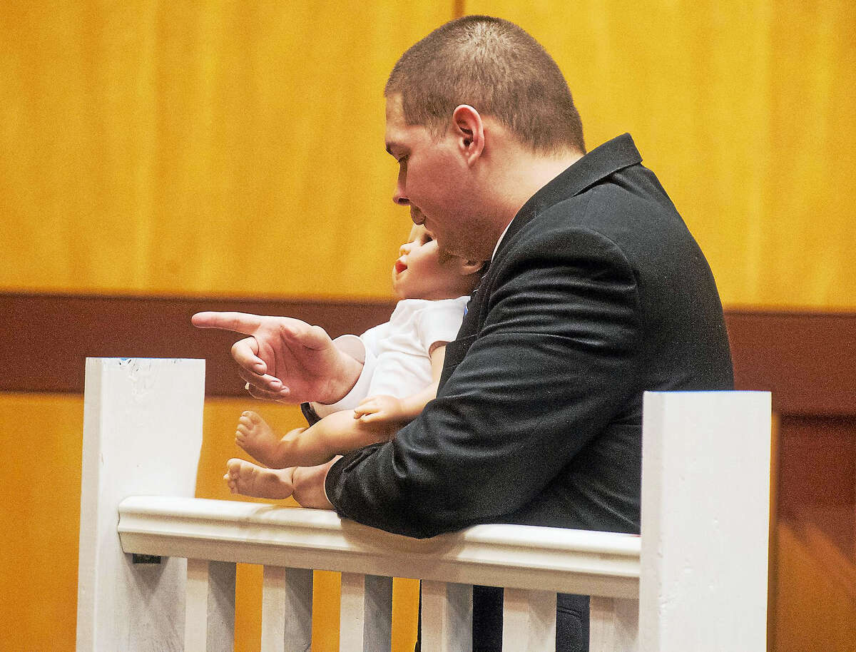 Patrick Raycraft — Hartford Courant, pool photo Tony Moreno demonstrates to the jury how he held his son Aaden on the railing of the Arrigoni Bridge in the final moments of Aaden’s life on July 5, 2015.