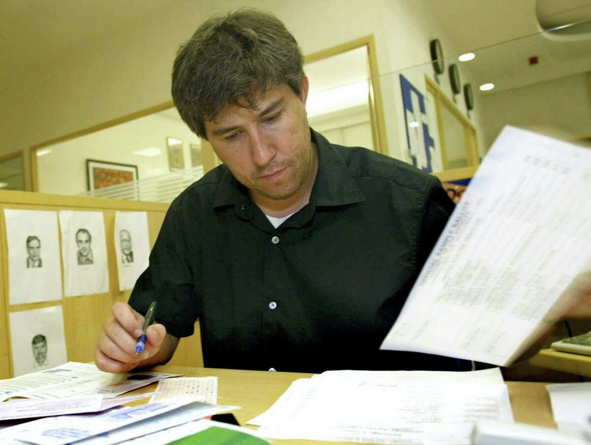 In this Thursday, Sept. 30, 2004, file photo, Wall Street Journal correspondent Jay Solomon, checks his papers as he fills his U.S. election absentee ballot at his office in New Delhi, India. The Wall Street Journal on June 21, 2017, fired Solomon, its chief foreign affairs correspondent, after evidence emerged about his involvement in prospective business deals, including one involving arms sales to foreign governments, with an international businessman who was one of his key sources. Solomon was offered a 10 percent stake in a fledgling company, Denx LLC, by Farhad Azima, an Iranian-born aviation magnate who ferried weapons for the CIA. It was not clear whether Solomon ever received money or formally accepted a stake in the company. Solomon did not immediately comment.