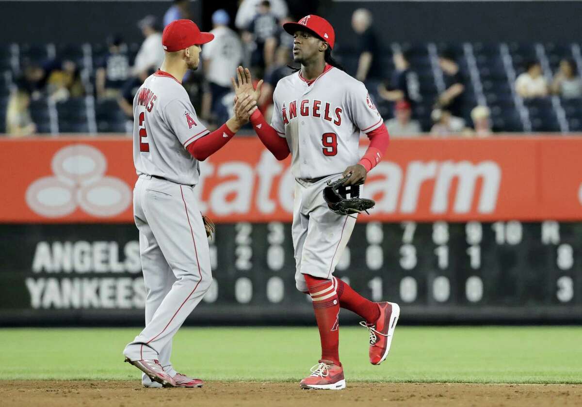 Los Angeles Angels’ Cameron Maybin (9) celebrates with Andrelton Simmons (2) after the Angels defeated the New York Yankees 8-3 in a baseball game Tuesday, in New York.