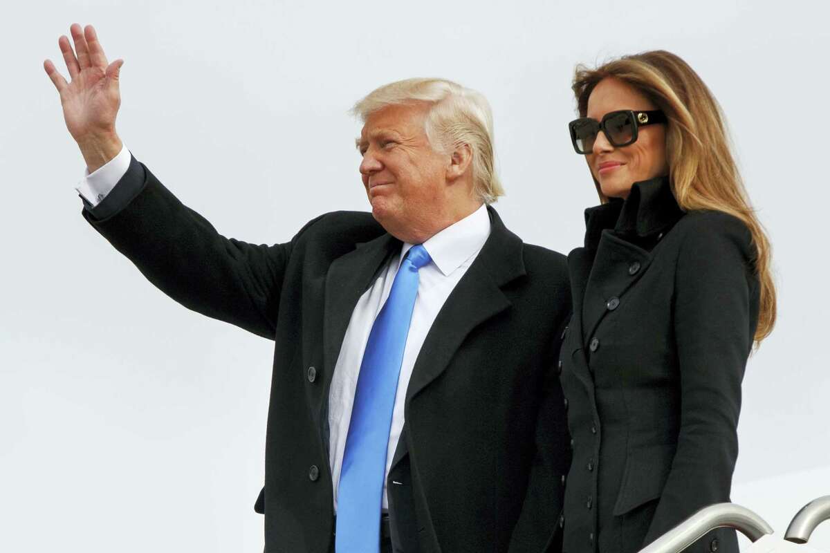 President-elect Donald Trump, accompanied by his wife Melania Trump, waves as they arrive at Andrews Air Force Base, Md., Thursday, Jan. 19, 2017, ahead of Friday’s inauguration.