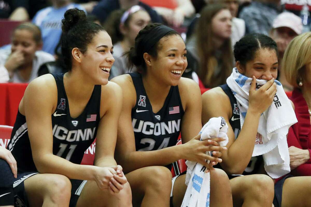 From left, UConn’s Kia Nurse, Napheesa Collier and Gabby Williams smile on the bench during a recent game.