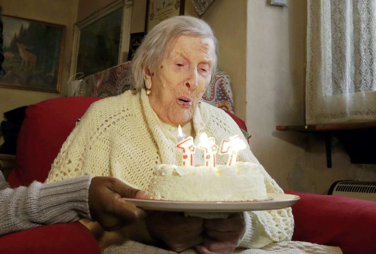 In this Nov. 29, 2016 photo, Emma Morano, 117 years old, blows candles on the day of her birthday in Verbania, Italy. An Italian doctor says Saturday, April 15, 2017 Emma Morano, at 117 the world’s oldest person, has died in her home in northern Italy. Dr. Carlo Bava told The Associated Press by telephone that Morano’s caretaker called him to say the woman had passed away Saturday afternoon while sitting in an armchair in her home in Verbania, a town on Lake Maggiore.
