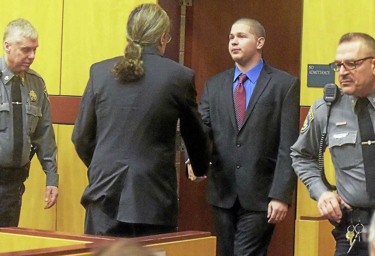 PATRICK RAYCRAFT — Hartford Courant/Pool Tony Moreno, shown entering the courtroom at the start of his murder trial on Friday morning, shakes hands with his attorney Norm Pattis.