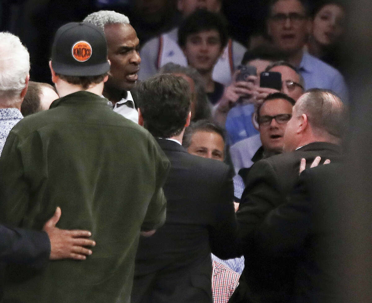 Former New York Knicks player Charles Oakley exchanges words with a security guard during the first half of a game between the New York Knicks and the LA Clippers, Wednesday in New York.