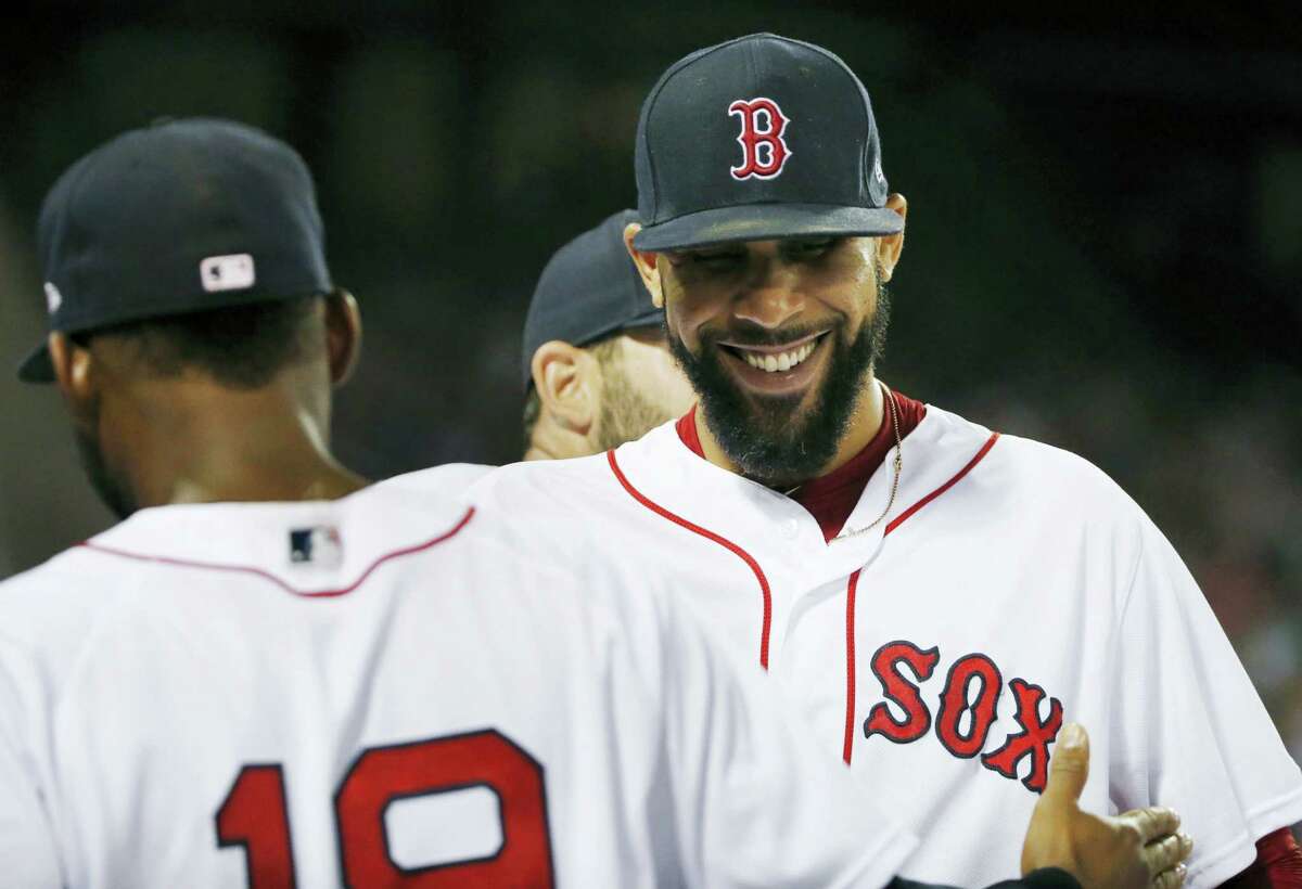 David Price, right, congratulates Jackie Bradley Jr. (19) after Bradley’s catch on a fly out by Aaron Judge during the eighth inning of the second game of doubleheader in Boston, on Sunday.)