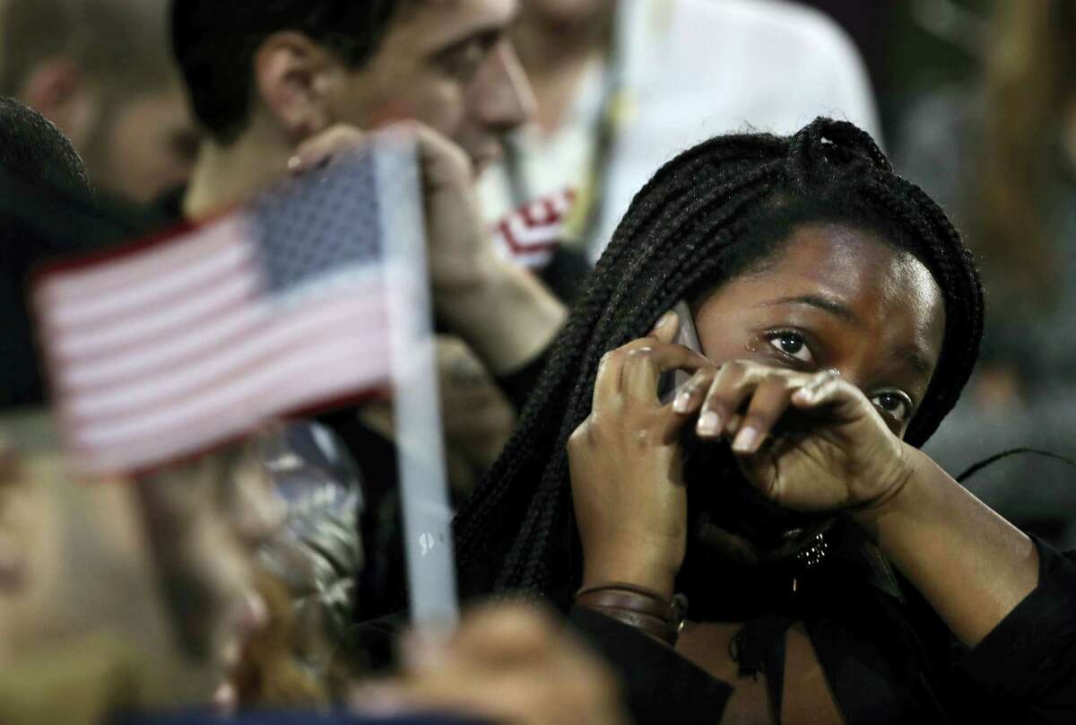 A woman weeps as election results are reported during Democratic presidential nominee Hillary Clinton’s election night rally in the Jacob Javits Center glass enclosed lobby in New York. As Donald Trump approaches his inauguration as president, young Americans have a deeply pessimistic view about his incoming administration, with young blacks, Latinos and Asian Americans particularly concerned about what’s to come in the next four years.
