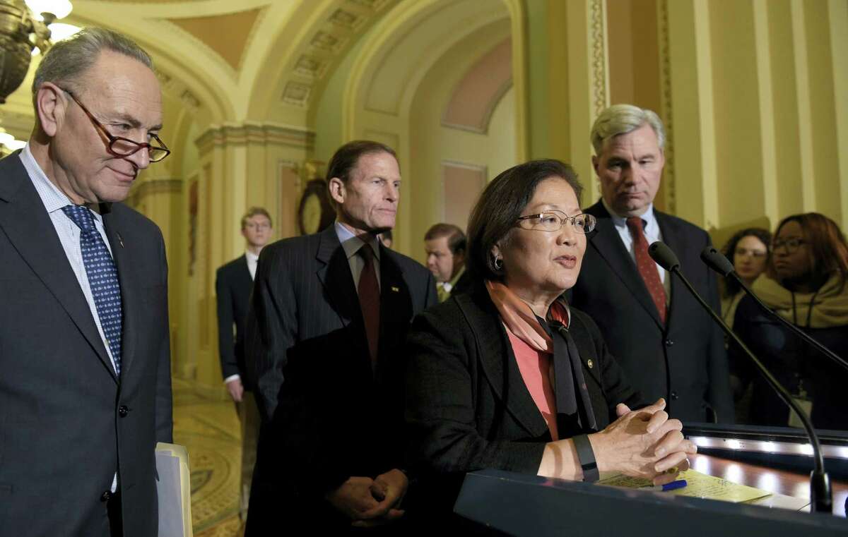 Sen. Mazie Hirono, D-Hawaii, second from right, speaks to reporters during a news conference on Capitol Hill in Washington, Tuesday, Feb. 7, 2017. From left are, Senate Minority Leader Charles Schumer of N.Y., Sen. Richard Blumenthal, D-Conn., and Sen. Sheldon Whitehouse, D-R.I.