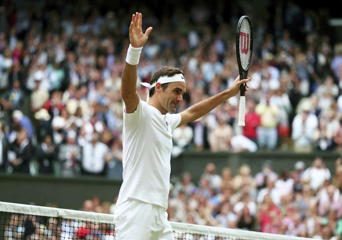 Roger Federer celebrates after beating Tomas Berdych in their men’s singles semifinal match at Wimbledon on Friday.