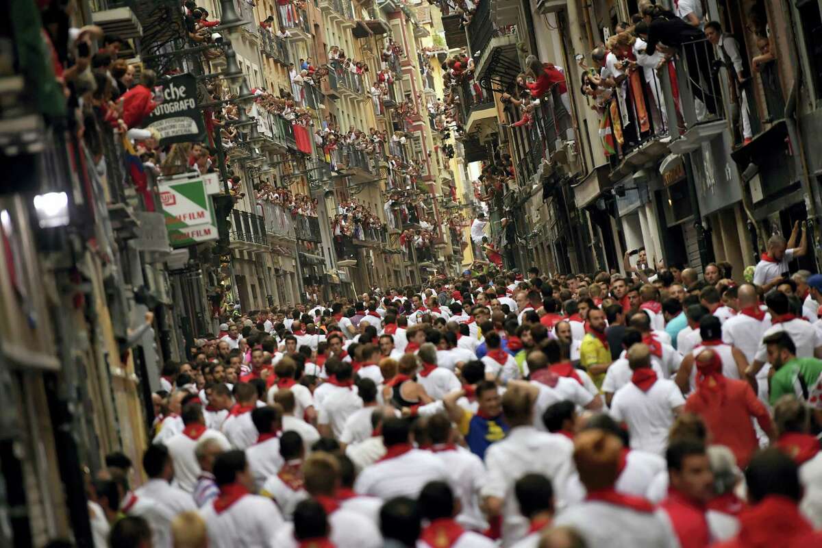 People pack the street ahead of the running of the bulls at the San Fermin Festival in Pamplona, northern Spain, Thursday, July 13, 2017. Revellers from around the world flock to Pamplona every year to take part in the eight days of the running of the bulls.