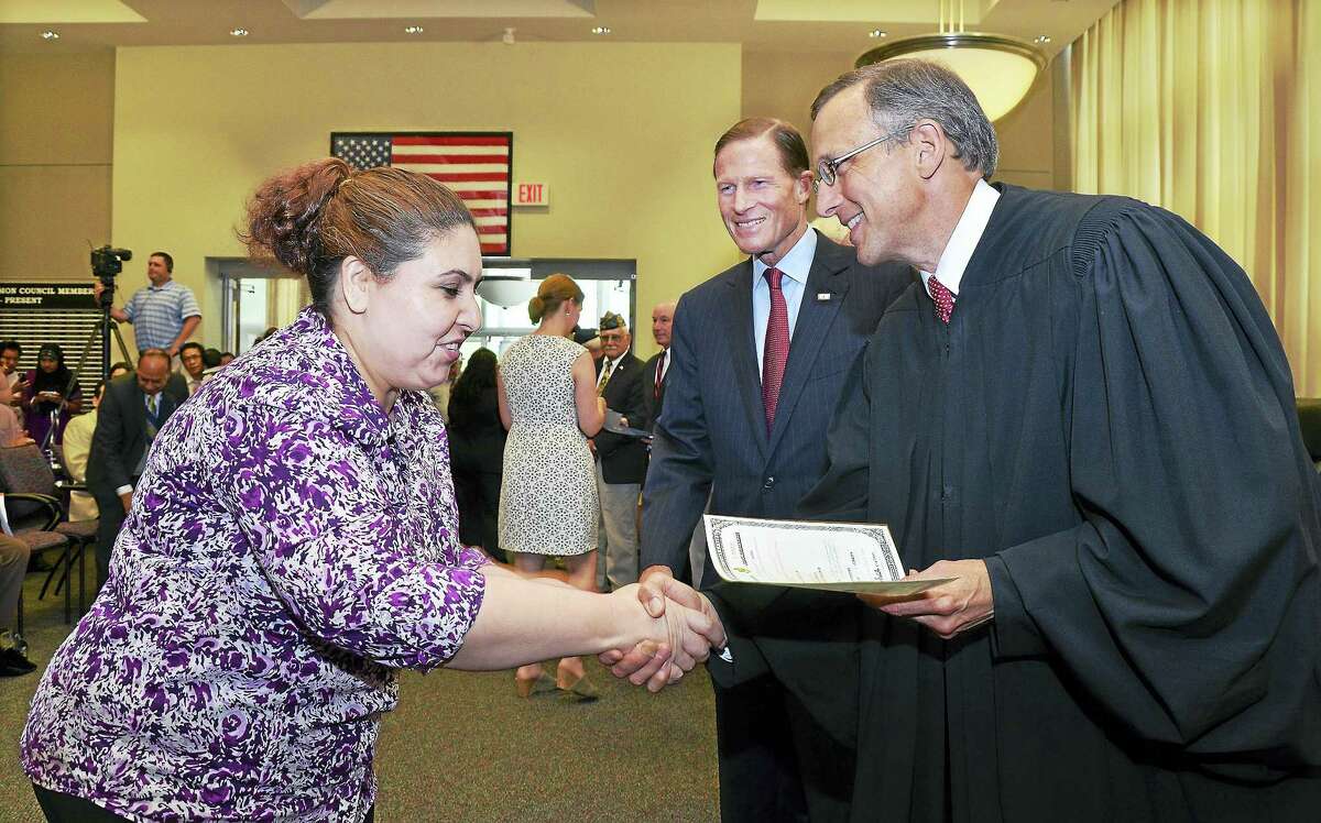 File photo New citizens register to vote following the city’s annual naturalization ceremony at Middletown City Hall in this file photograph. Mayor Dan Drew declared the city a safe haven for immigrants last week, saying local law enforcement will not do the U.S. government’s job by enforcing federal immigration laws following President Donald J. Trump’s executive order of Jan. 27.