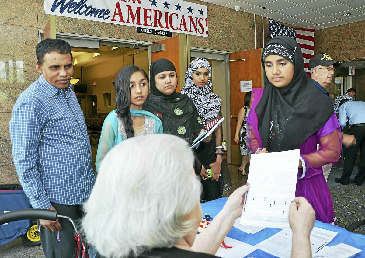 New citizens register to vote following the city’s annual naturalization ceremony at Middletown City Hall in this file photograph. Mayor Dan Drew declared the city a safe haven for immigrants last week, saying local law enforcement will not do the U.S. government’s job by enforcing federal immigration laws following President Donald J. Trump’s executive order of Jan. 27.