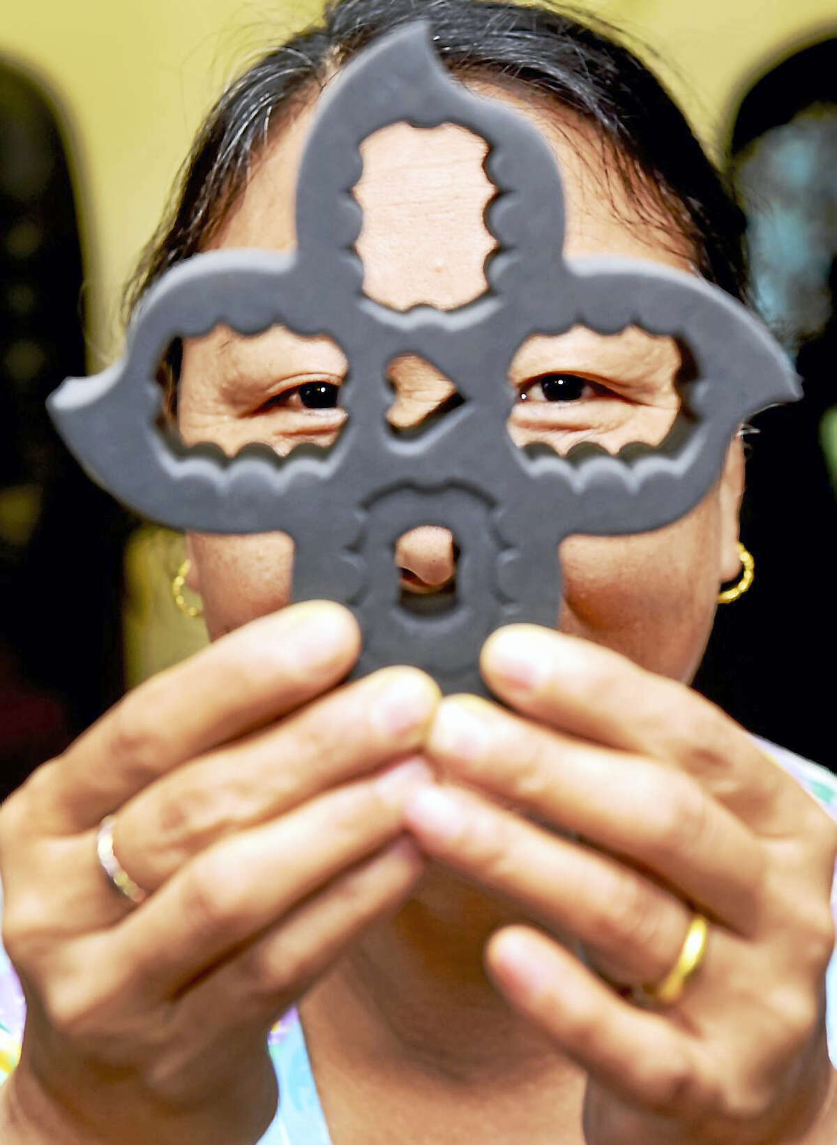 (Peter Hvizdak - New Haven Register) Kunga Choekyi, owner of K.C.’s Nails L.L.C. of Old Saybrook, a manicure and pedicure nail salon, with her patented invention, a nail polish holder called the Polish Posy, in the design of a lotus flower. The Polish Posy enables anyone to safely hold, tilt, and transport the bottles. Cyoekyi is a Tibetan and a follower of the Dalai Lama. A portion of the proceeds of the Polish Posy will go to organizations that care for Tibetan refugee children in southern India and to local charities.