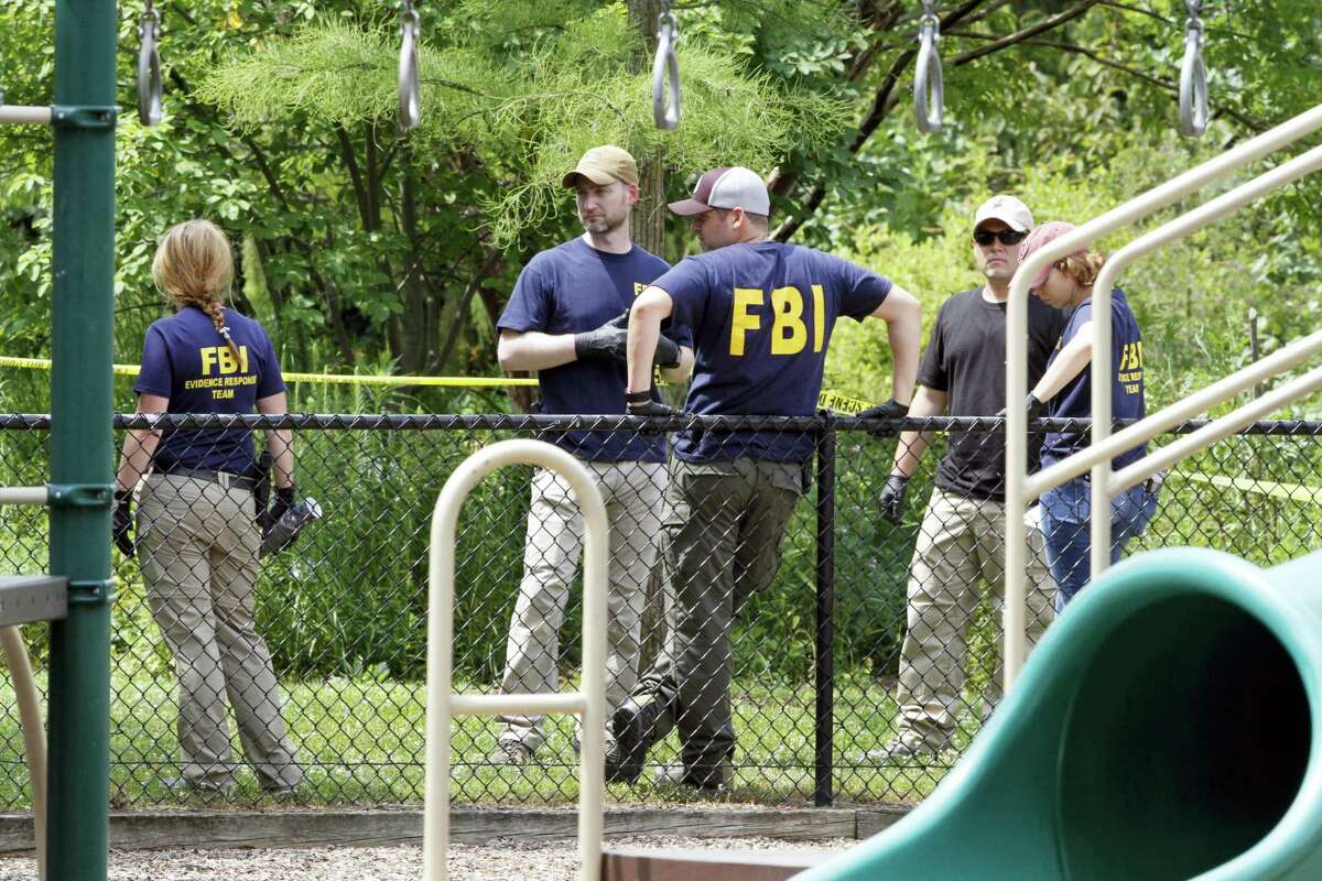 FBI agents investigate a playground near the baseball field in Alexandria, Va., Thursday, June 15, 2017, the day after House Majority Whip Steve Scalise of La. was shot during during a congressional baseball practice at the park. (AP Photo/Jacquelyn Martin)