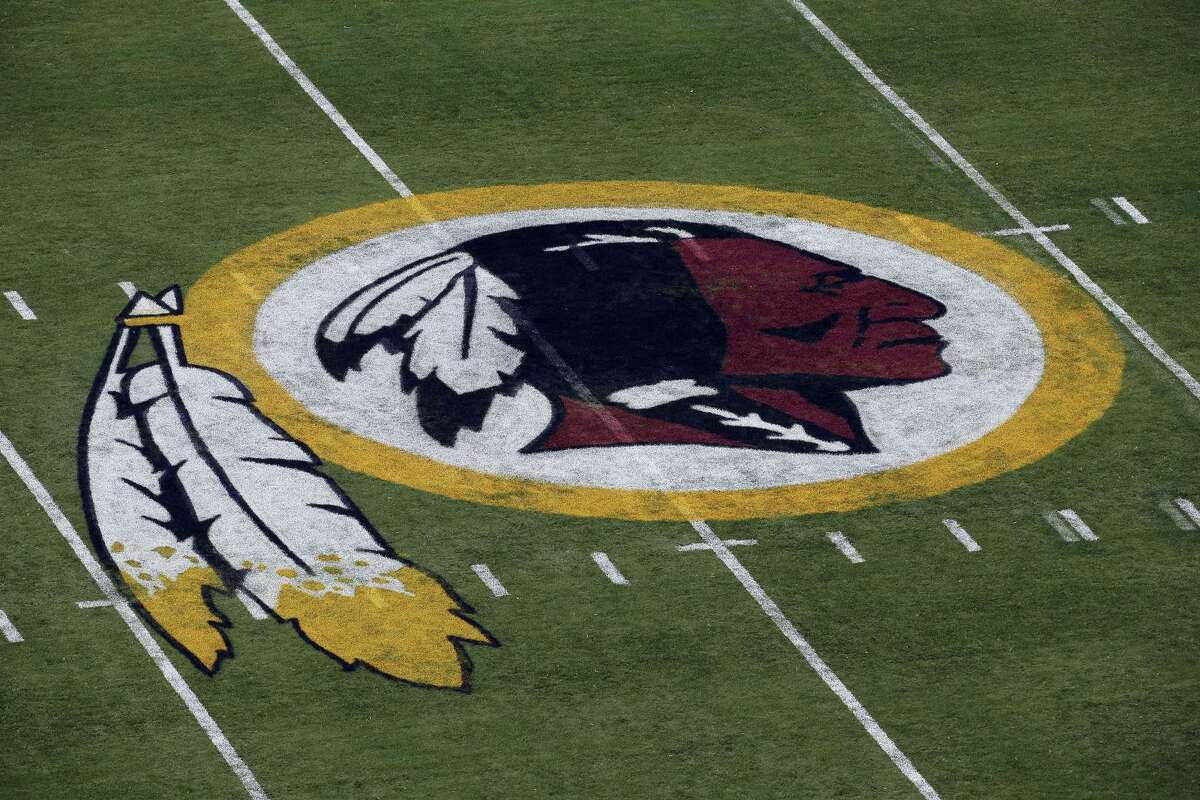In this Aug. 7, 2014 photo, the Washington Redskins logo is seen on the field before an NFL football preseason game against the New England Patriots in Landover, Md. A First Amendment fight will play out Wednesday, Jan. 18, 2017 in the Supreme Court, as the justices consider whether a law barring disparaging trademarks violates free speech rights.