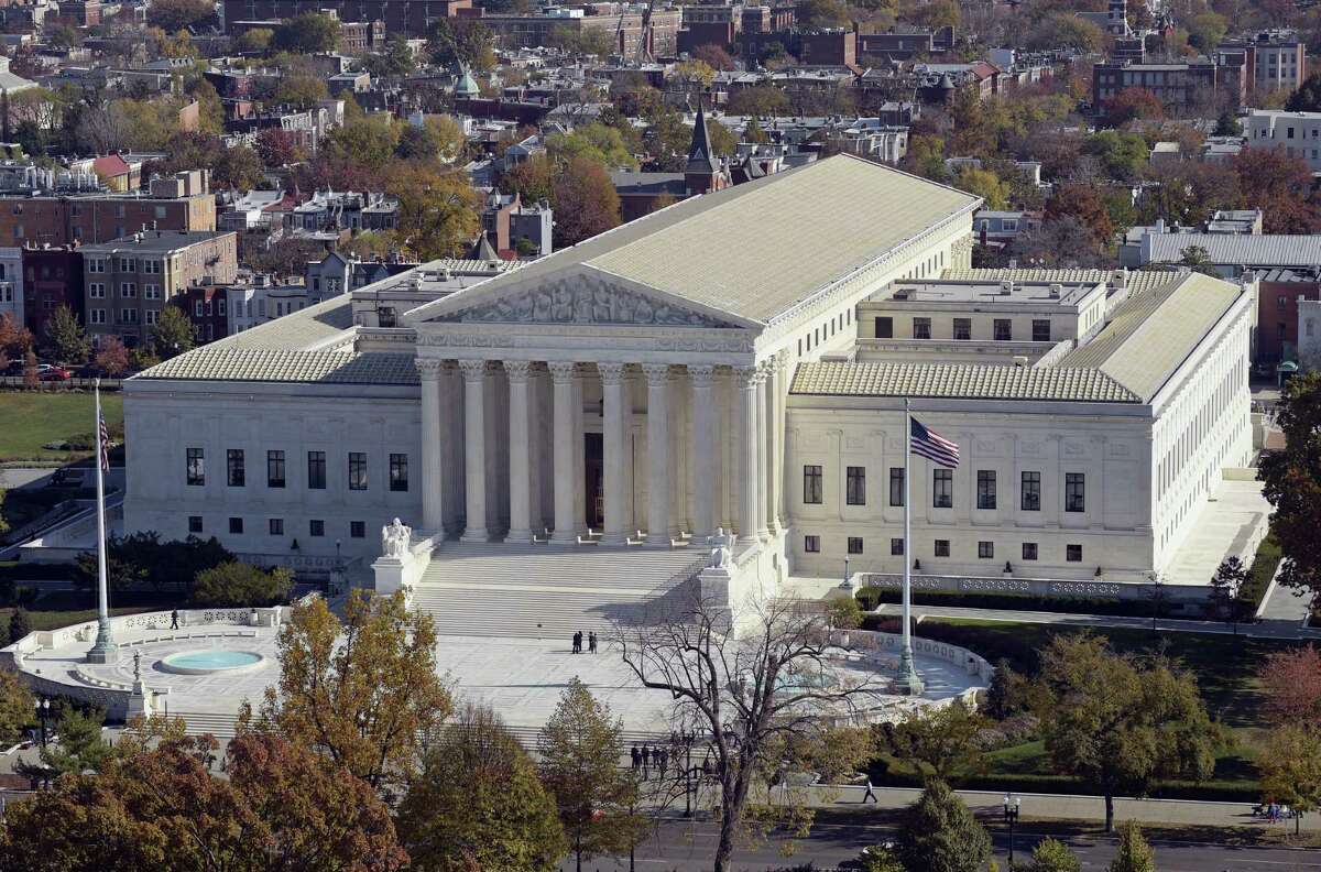 A view of the Supreme Court from the Capitol Dome, on Capitol Hill in Washington. An Asian-American rock band called the Slants has spent years locked in a legal battle with the government over its refusal to trademark the band’s name. The fight will play out Wednesday at the Supreme Court as the justices consider whether a law barring disparaging trademarks violates the band’s free speech rights.