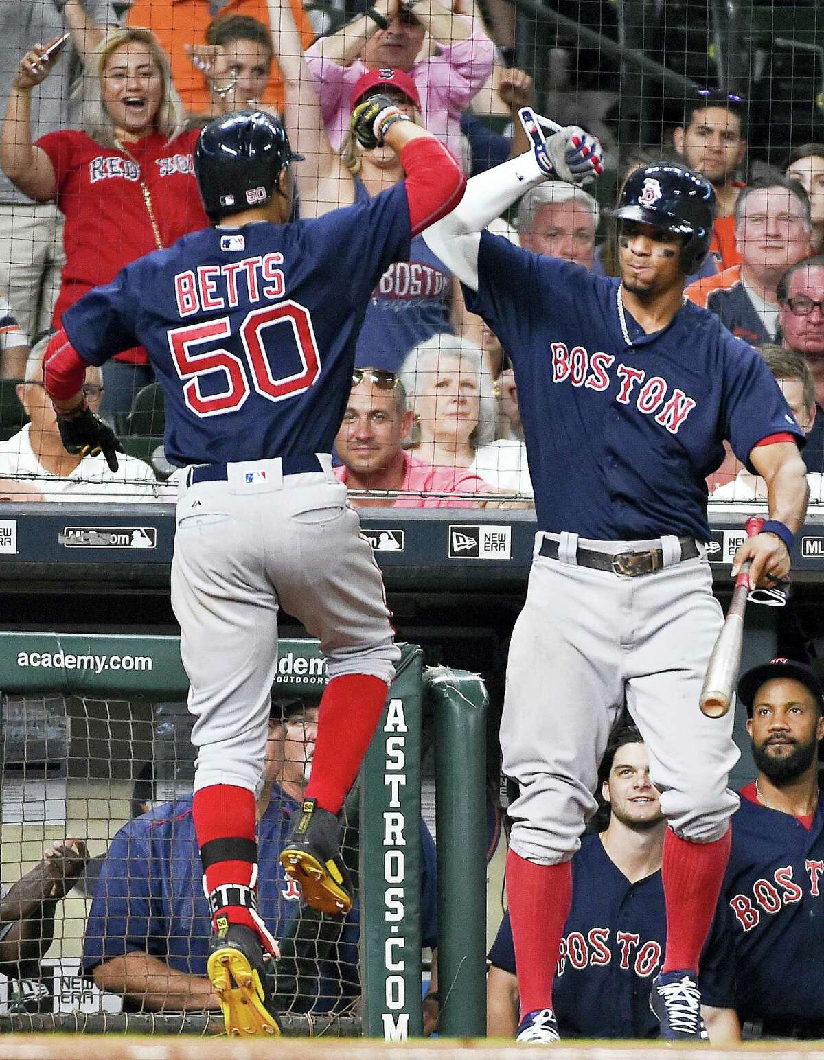 Mookie Betts (50) celebrates his go-ahead solo home run with Xander Bogaerts during the eighth inning Friday in Houston.