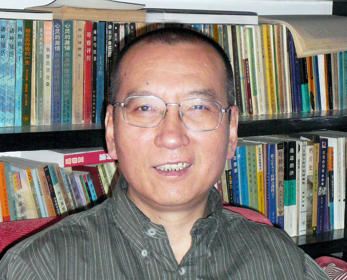 FILE - In this April 2008 file photo shows Chinese dissident Liu Xiaobo as he poses for a photographer in China. The judicial bureau in the northeastern Chinese city of Shenyang says jailed Nobel Peace Prize laureate Liu Xiaobo has died of multiple organ failure Thursday, July 13, 2017, at age 61. (AP Photo/Kyodo News, File)