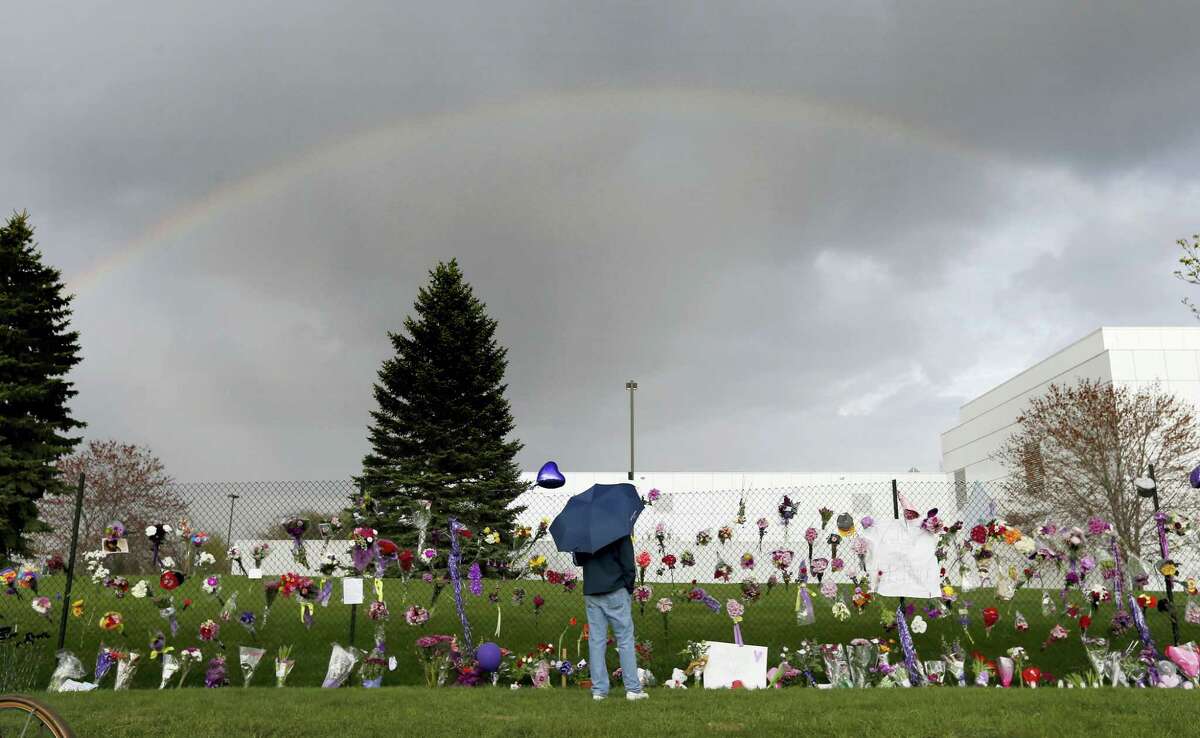 In this April 21, 2016 photo, a rainbow appears over Prince’s Paisley Park estate near a memorial for the rock superstar in Chanhassen, Minn. Nearly a year after Prince died from an accidental drug overdose in his suburban Minneapolis studio and estate, investigators still haven’t interviewed a key associate nor asked a grand jury to investigate potential criminal charges, according to an official with knowledge of the investigation.