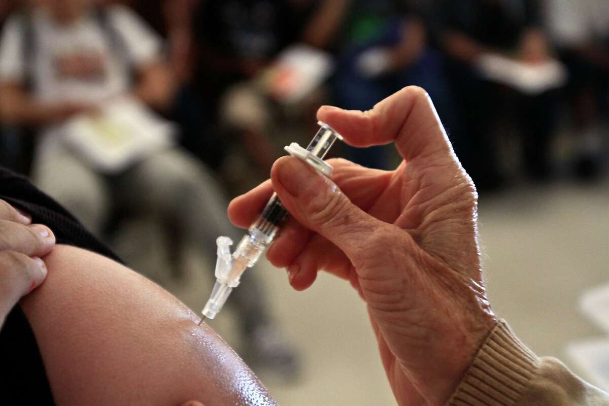 A student receives a whooping cough vaccination in this file photo.