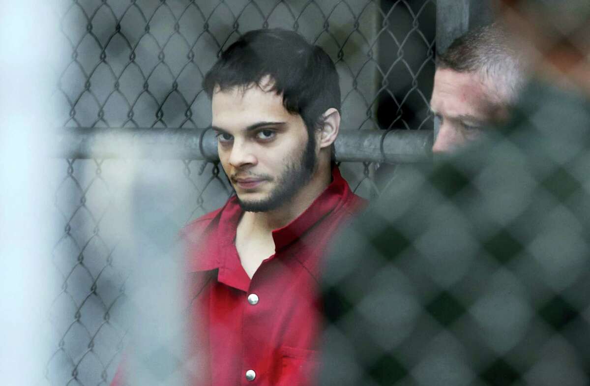 Esteban Santiago is taken from the Broward County main jail as he is transported to the federal courthouse in Fort Lauderdale, Fla. Amy Beth Bennett — South Florida Sun-Sentinel via AP