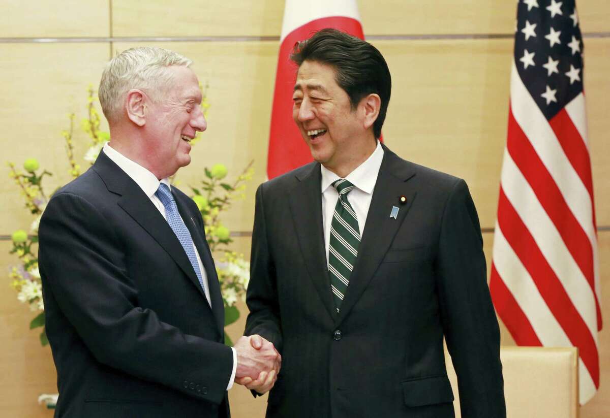 U.S. Defense Secretary Jim Mattis, left, and Japanese Prime Minister Shinzo Abe, right, shake hands at the prime minister’s office in Tokyo, Friday, Feb. 3, 2017. In an explicit warning to North Korea, U.S. Defense Secretary Mattis on Friday said any use of nuclear weapons by the North on the United States or its allies would be met with what he called an “effective and overwhelming” response.