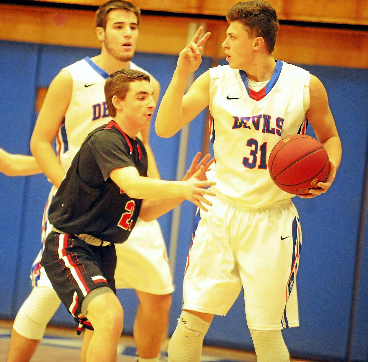 Coginchaug junior Hunter Jameson calls the play while being guarded by Cromwell’s David Dewey on Friday.