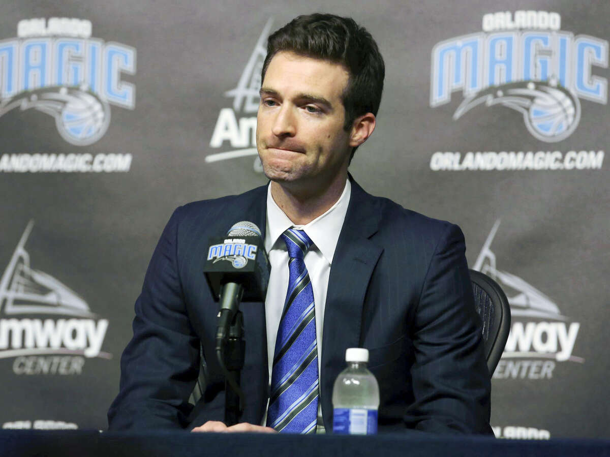 In this Feb. 5, 2015 photo, Orlando Magic general manager Rob Hennigan pauses to answer a question during a news conference in Orlando, Fla. The Orlando Magic have fired general manager Rob Hennigan after missing the postseason for five straight seasons. The team confirmed the dismissal on April 13, 2017.