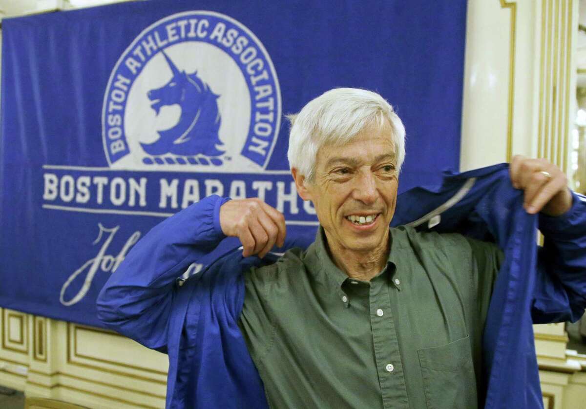 Ben Beach dons a Boston Marathon jacket before a media availability near the Boston Marathon finish line Thursday in Boston. Beach is on the verge of becoming the first person to run the Boston Marathon 50 consecutive times if he completes the race on Monday.