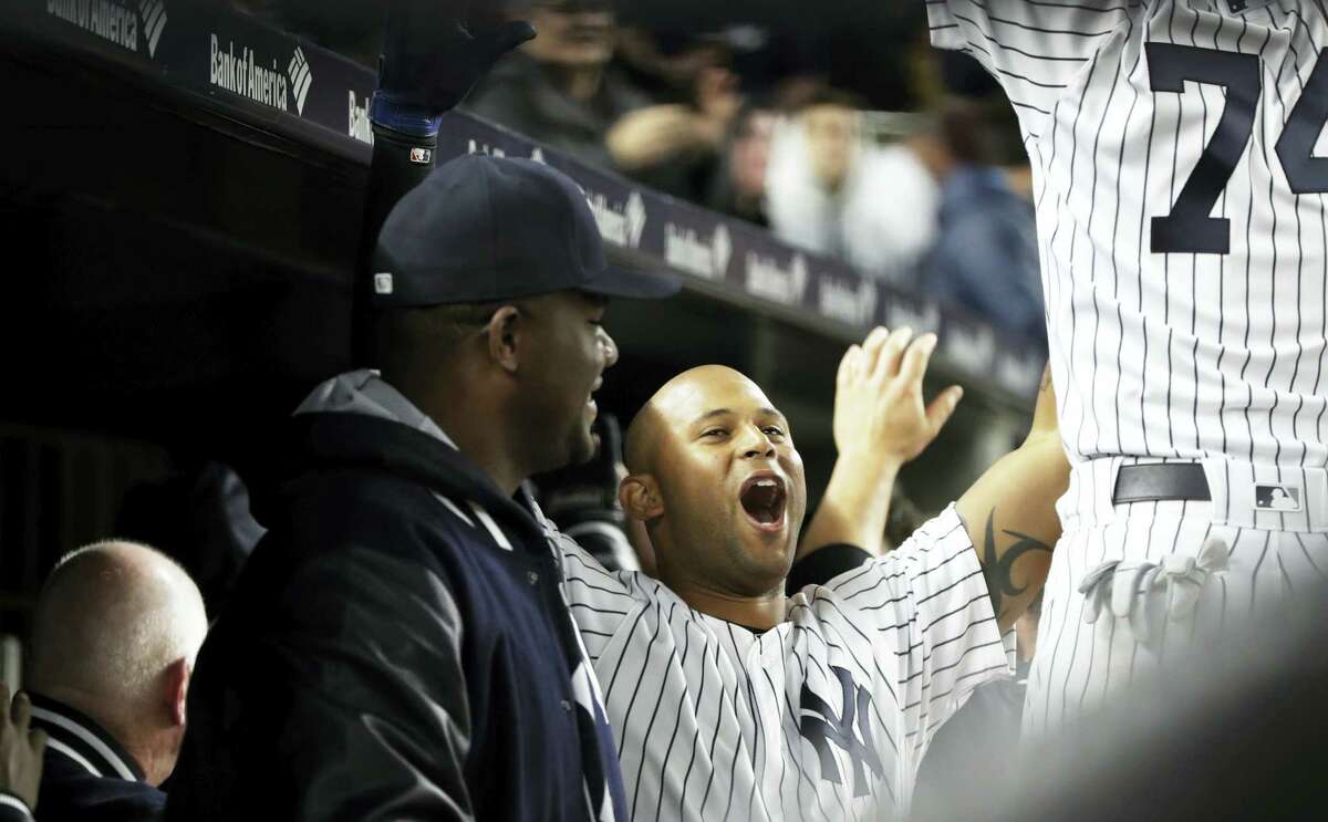 The Yankees’ Aaron Hicks celebrates with teammates after hitting a two-run home run during the seventh inning against the Rays on Thursday.