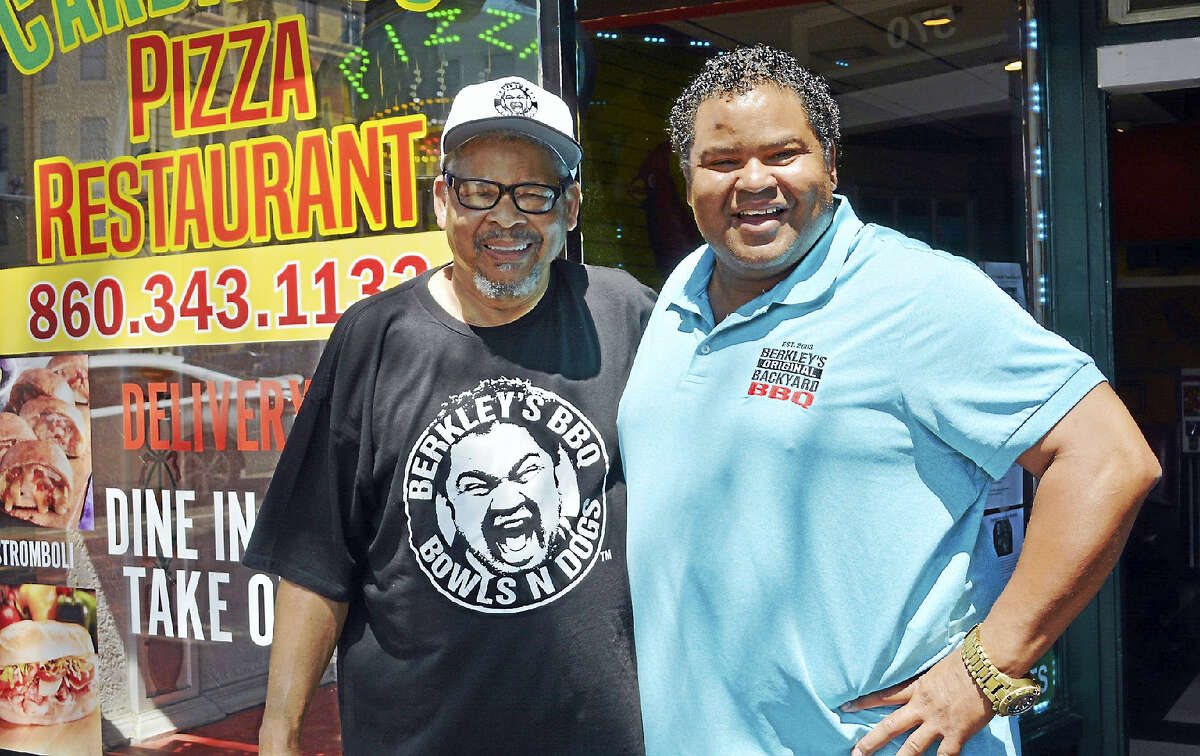 Raymond Hoagland, left, and son Berkley Hoagland, formerly of Middletown and East Hampton, stand out front of Cardinal’s Pizza on Main Street in Middletown, the location of the former Hoagie’s BBQ and Pizza, the second incarnation of their popular North End ribs restaurant. Hoagies BBQ, which burned in a fire in the early 80s, began next door to where Keagan’s Irish Bar stands now. The eatery later moved to Cromwell Square Shopping Center on Shunpike Road for a time.
