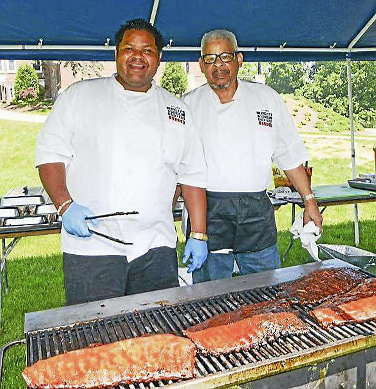 Raymond and Berkley Hoagland work the grill at a barbecue at Cushing Academy in Massachusetts, where Berkley Hoagland went to prep school. They cooked for the crowds at the annual alumni association gathering last weekend.