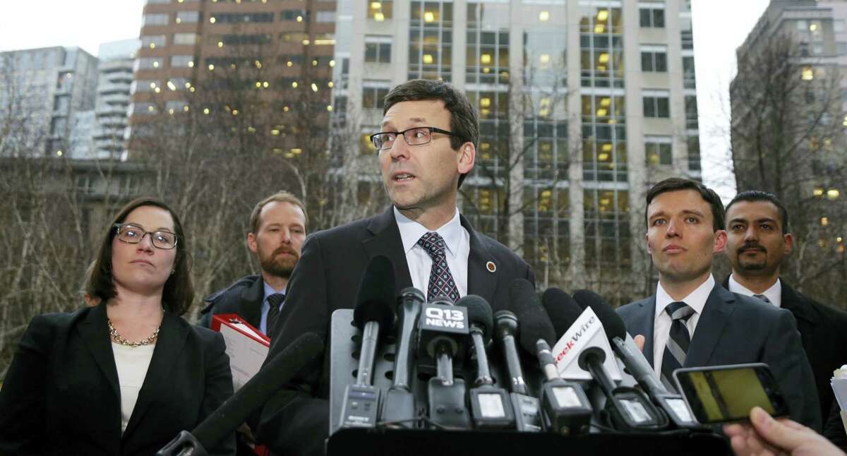 Washington Attorney General Bob Ferguson, center, talks to reporters as Solicitor General Noah Purcell, second from right, looks on, Friday, Feb. 3, 2017, following a hearing in federal court in Seattle. A U.S. judge on Friday temporarily blocked President Donald Trump’s ban on people from seven predominantly Muslim countries from entering the United States after Washington state and Minnesota urged a nationwide hold on the executive order that has launched legal battles across the country.