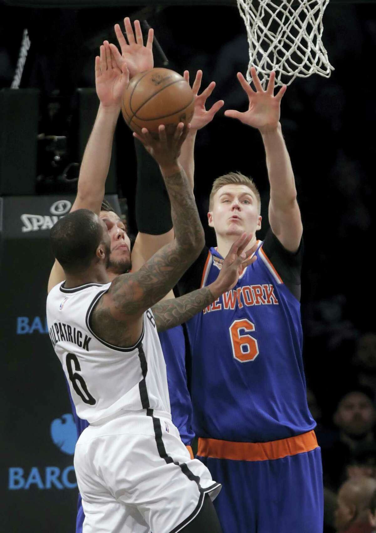 New York Knicks’ Kristaps Porzingis (6), and teammate Willy Hernangomez defend as Brooklyn Nets’ Sean Kilpatrick (6) Wednesday in New York.
