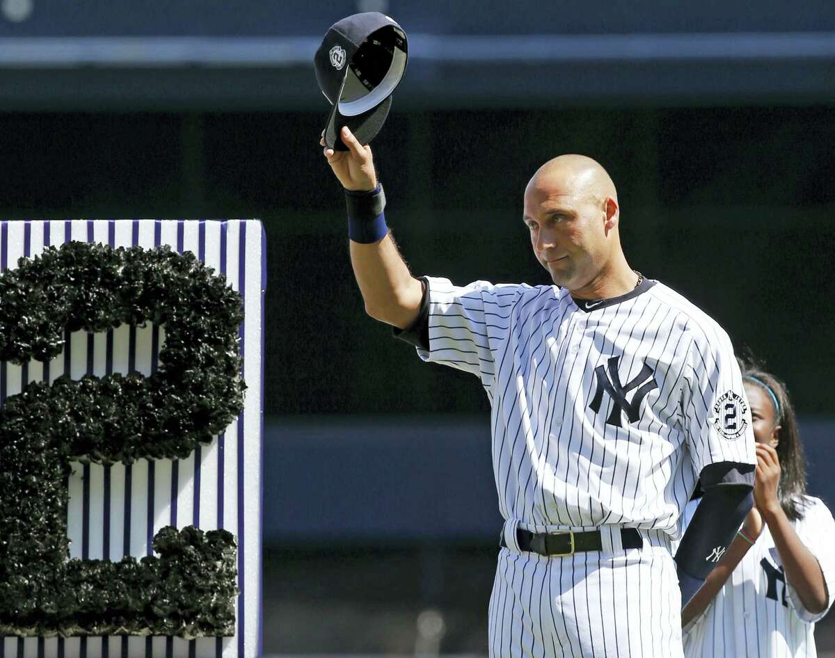 In this Sept. 7, 2014 photo, New York Yankees’ Derek Jeter (2) tips his cap to fans during a pregame ceremony honoring the Yankees captain. Jeter wrote an essay published May 11, 2017 on his Players’ Tribune site thanking the city before his No. 2 jersey is permanently retired by the team on May 14.