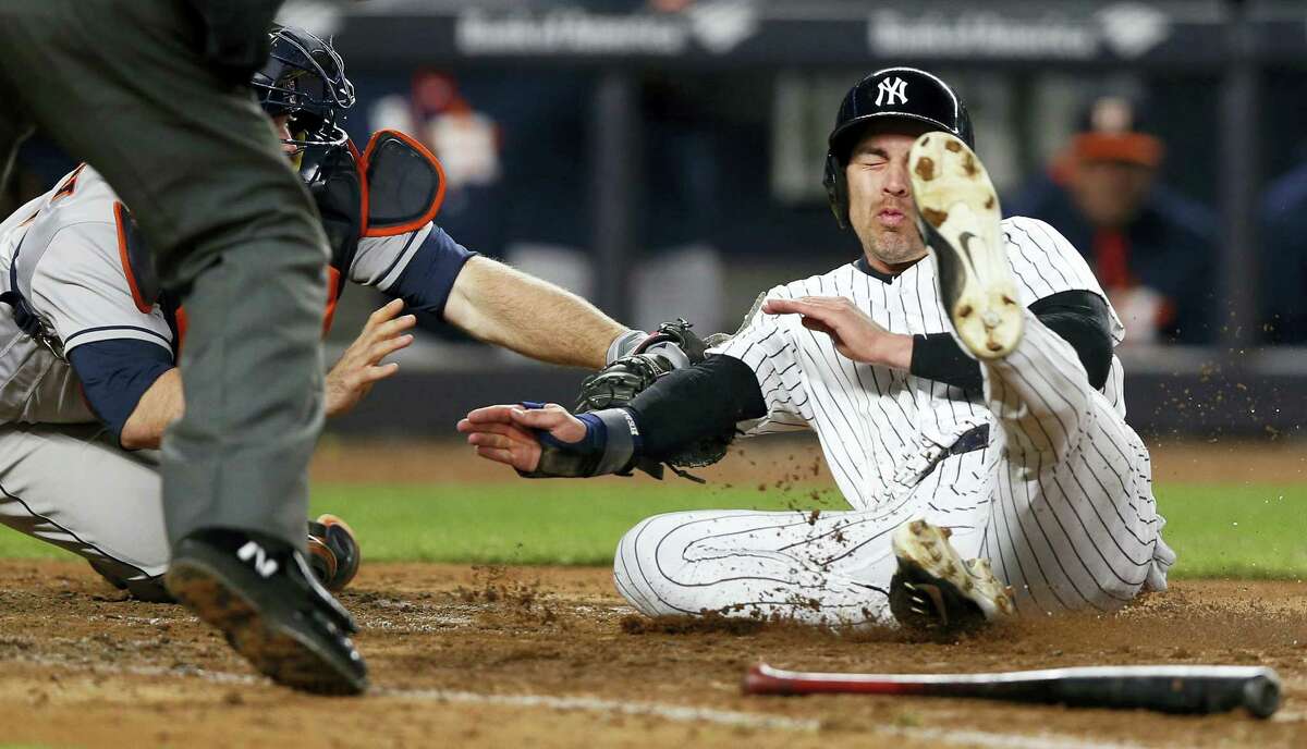 Astros catcher Brian McCann, left, tags out Jacoby Ellsbury at the plate for the final out Thursday.