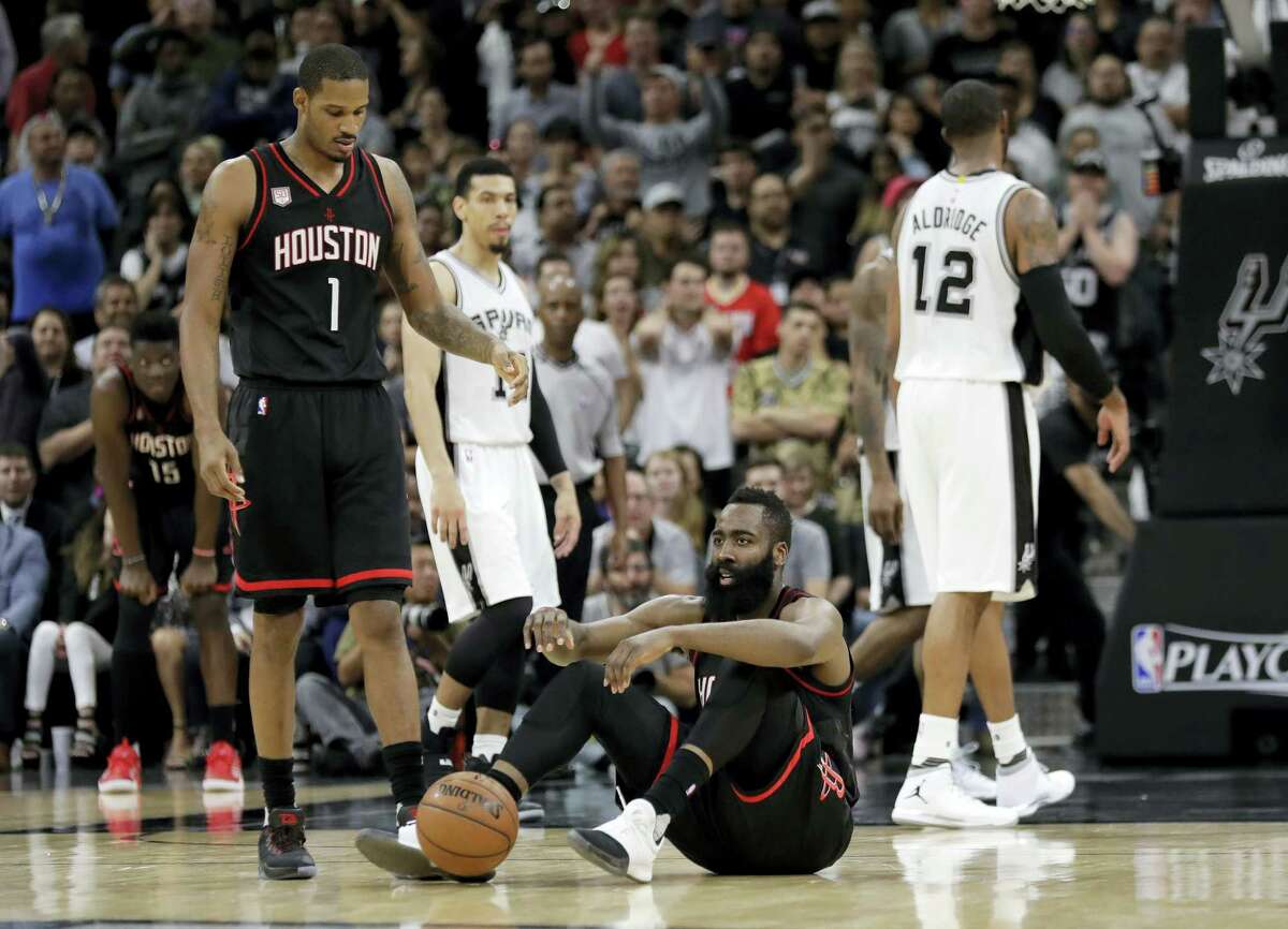 Houston Rockets’ James Harden (13) sits on the court as Trevor Ariza (1) walks over during overtime of Game 5 in a second-round NBA basketball playoff series against the San Antonio Spurs on May 9, 2017 in San Antonio. San Antonio won 110-107.