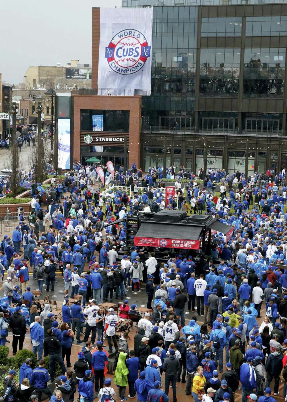 Fans gather outside in the Park at Wrigley before a baseball game between the Chicago Cubs and the Los Angeles Dodgers on home opening day April 10, 2017 in Chicago.