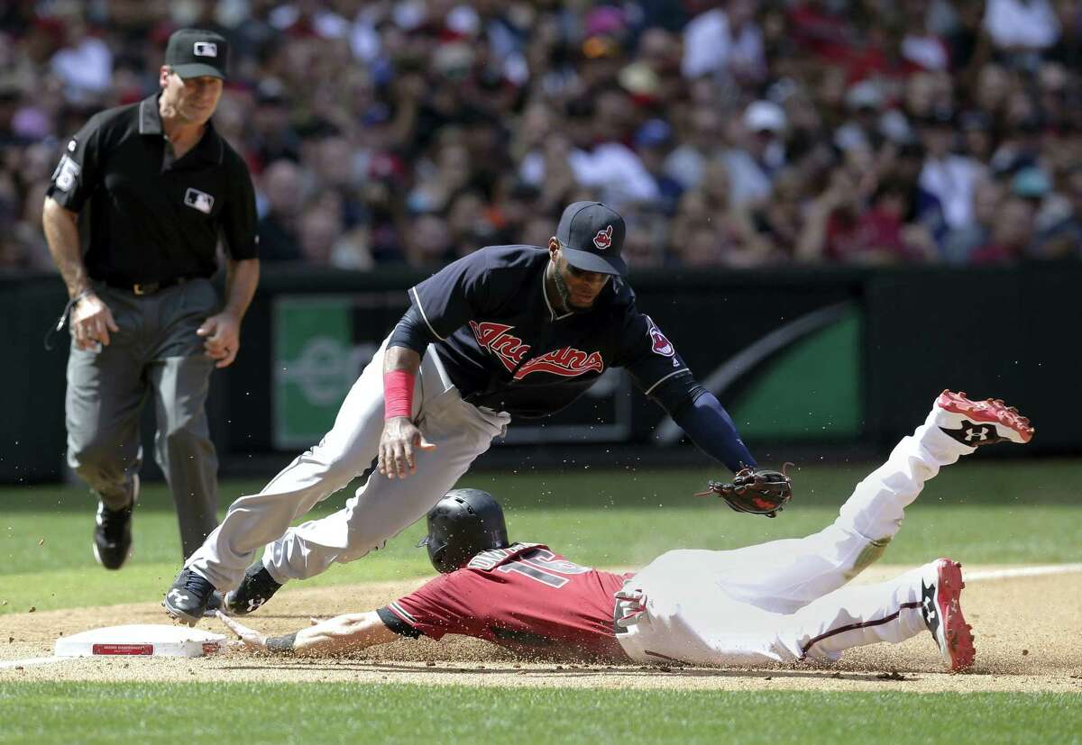 Cleveland Indians third baseman Yandy Diaz, left, tries to put the tag on Arizona Diamondbacks Chris Owings, right, in the fourth inning during a baseball game on April 9, 2017 in Phoenix.