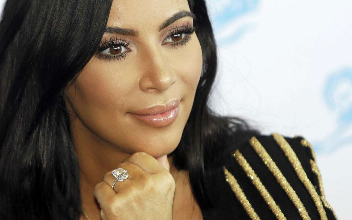 In this June 24, 2015 photo, American TV personality Kim Kardashian attends the Cannes Lions 2015 International Advertising Festival in Cannes, southern France. Paris police on Jan.9, 2017 say 16 people have been arrested over Kim Kardashian jewelry heist.