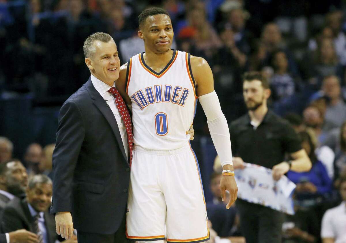 Oklahoma City Thunder guard Russell Westbrook (0) is hugged by head coach Billy Donovan after tying the record for triple-doubles in a season in the third quarter of an NBA basketball game against the Milwaukee Bucks in Oklahoma City on April 4, 2017.